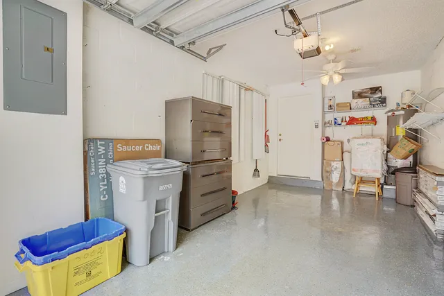 a living room with a flat screen tv and kitchen view