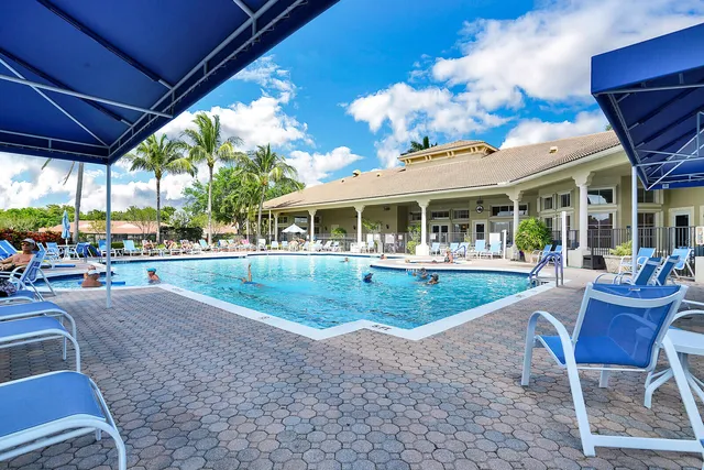 an aerial view of a house with a lake