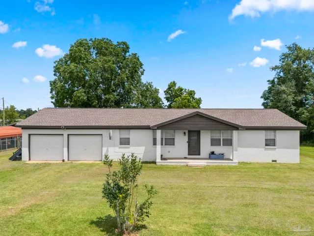 a front view of a house with a garden