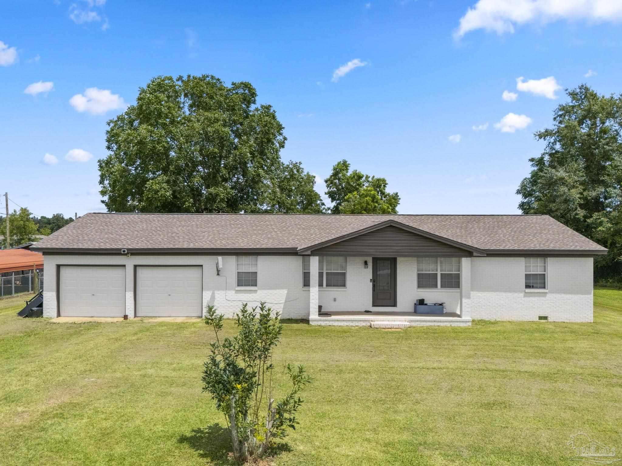 2065 Brownsdale Loop Road Jay, FL 32565 - Photo 1 of 25 a front view of a house with a garden