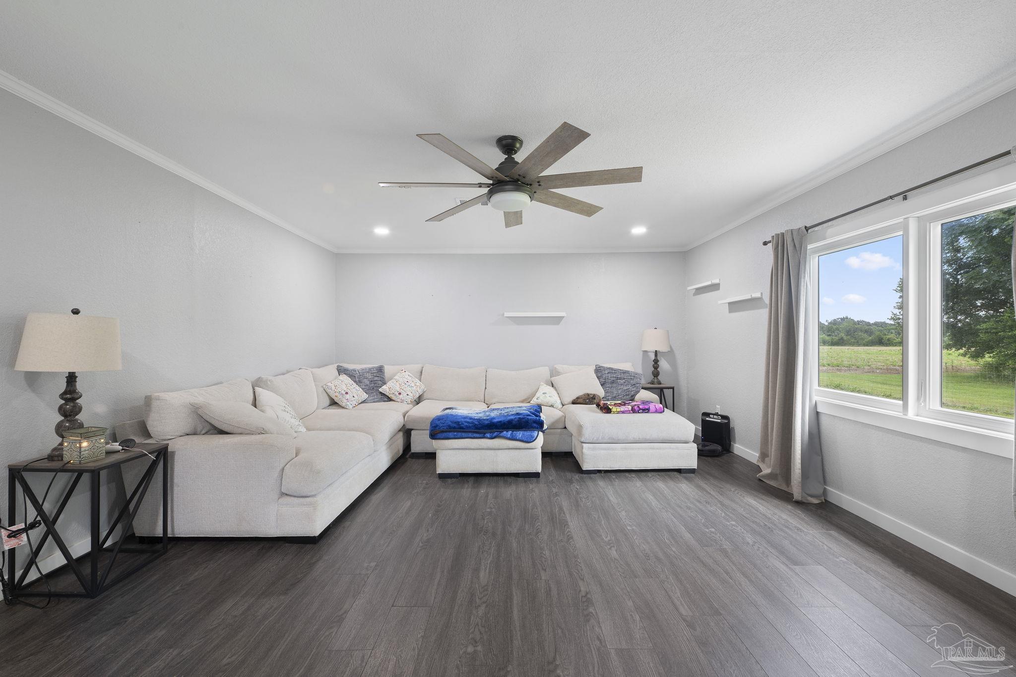 2065 Brownsdale Loop Road Jay, FL 32565 - Photo 11 of 25 a living room with furniture and three large windows