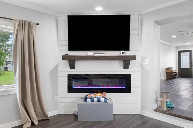a living room with flat screen tv and a fireplace