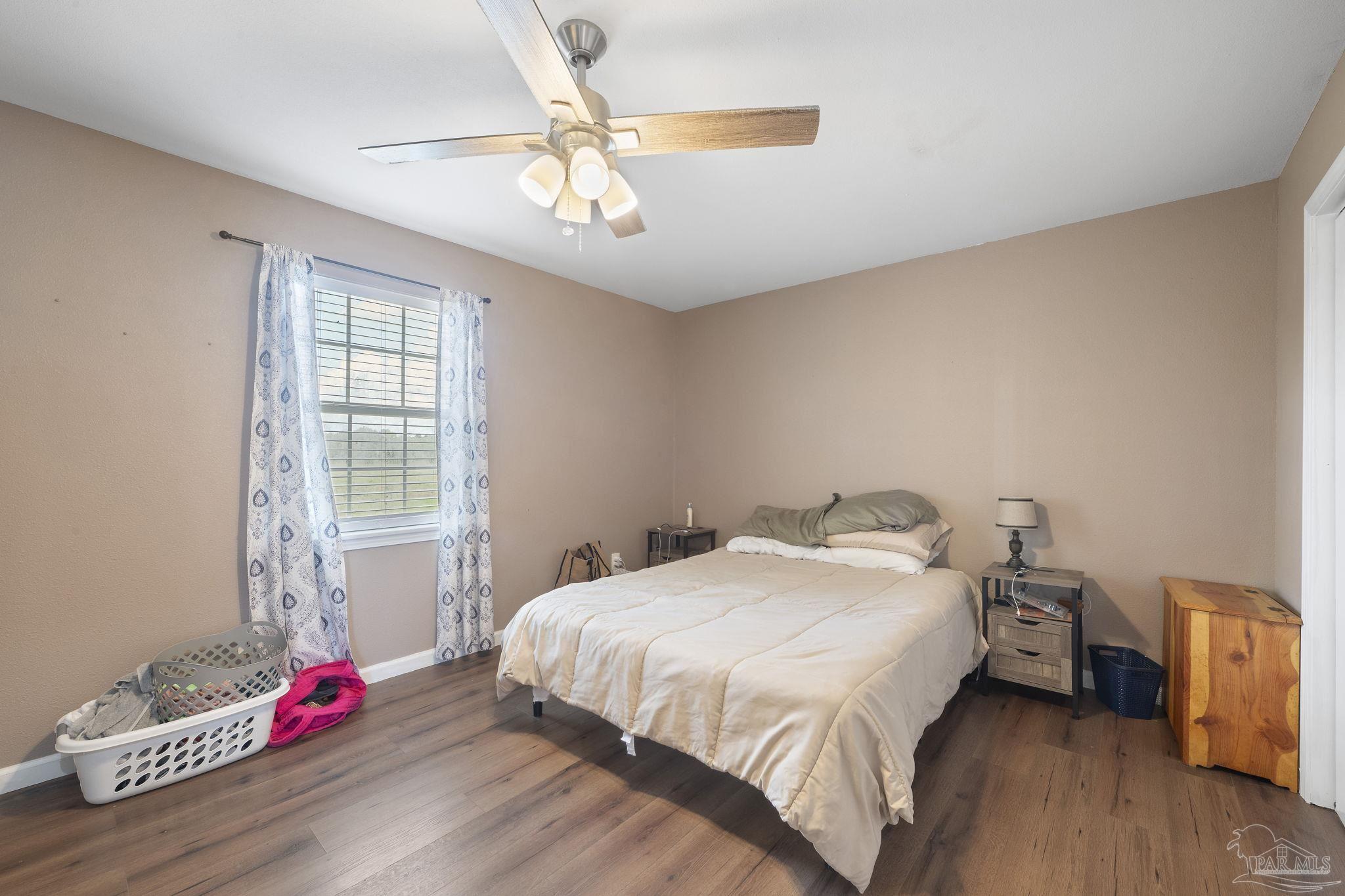 2065 Brownsdale Loop Road Jay, FL 32565 - Photo 14 of 25 a bedroom with a bed and a chandelier