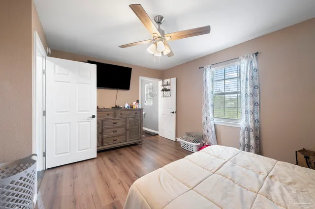 a bedroom with a bed and wooden floor