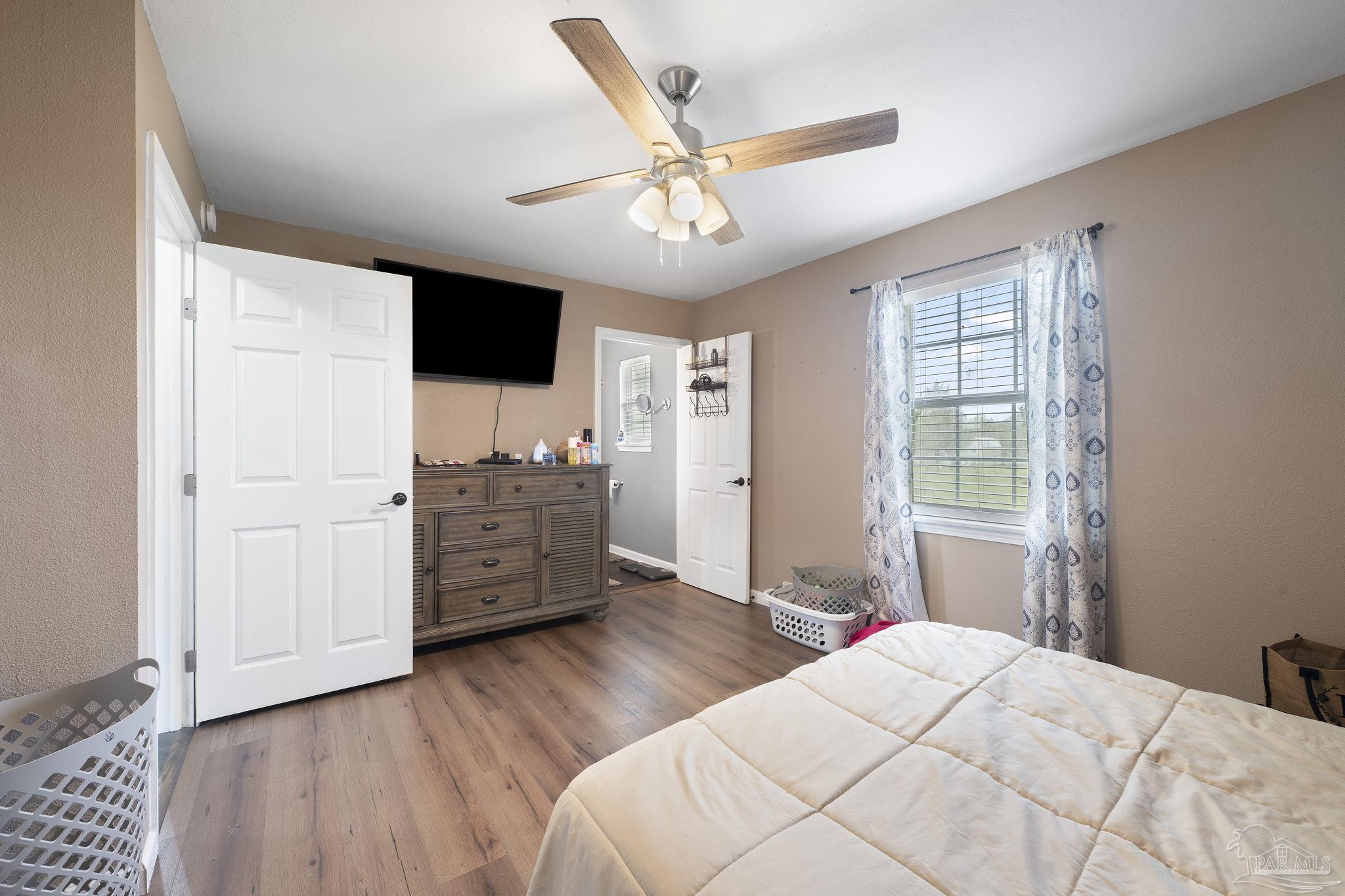 2065 Brownsdale Loop Road Jay, FL 32565 - Photo 16 of 25 a bedroom with a bed and wooden floor