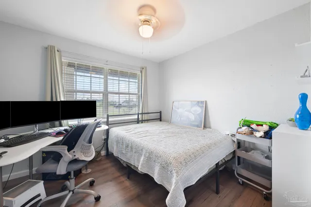 a bedroom with a bed and a desk