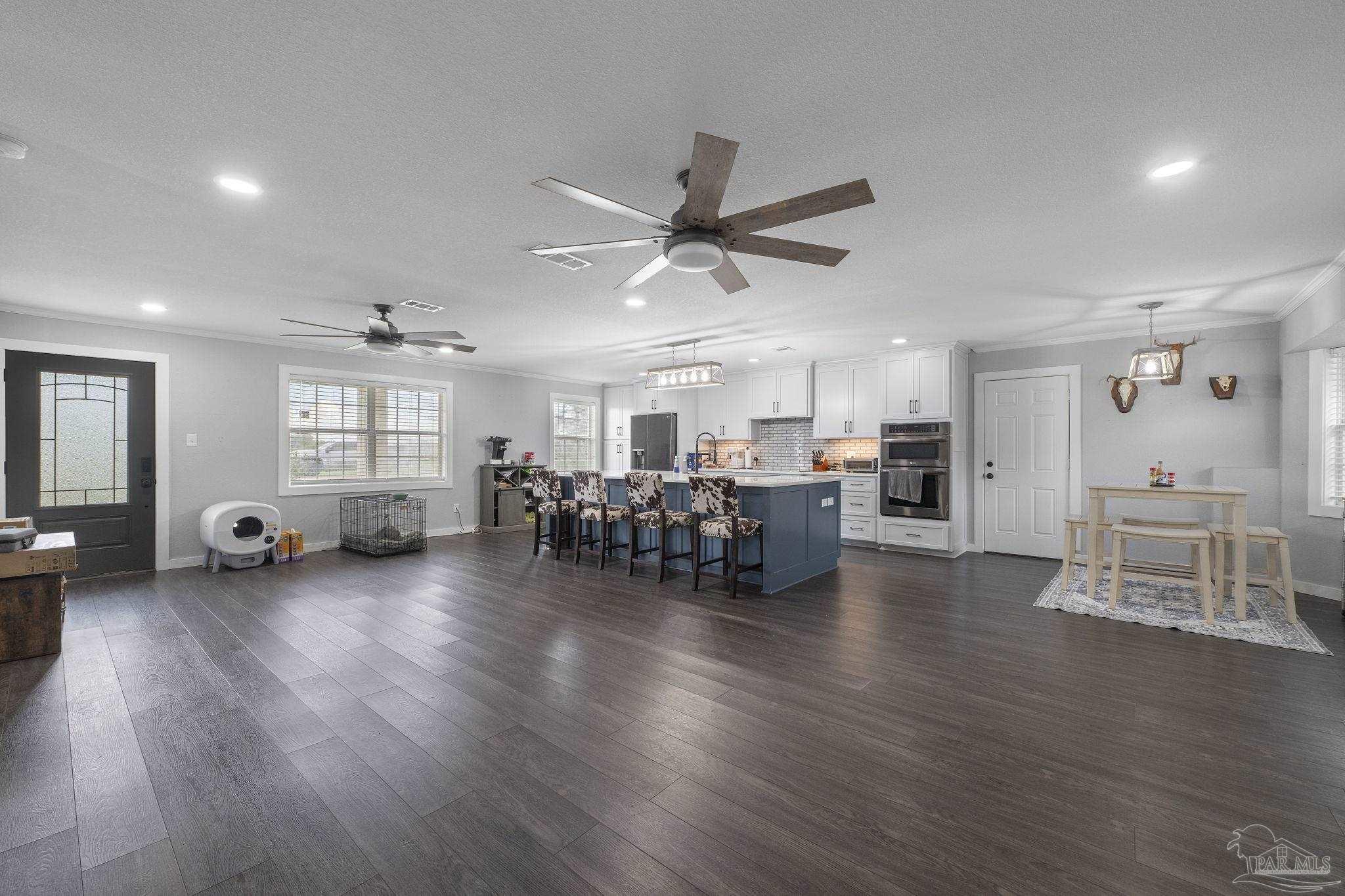 2065 Brownsdale Loop Road Jay, FL 32565 - Photo 4 of 25 a living room with furniture and kitchen view with wooden floor