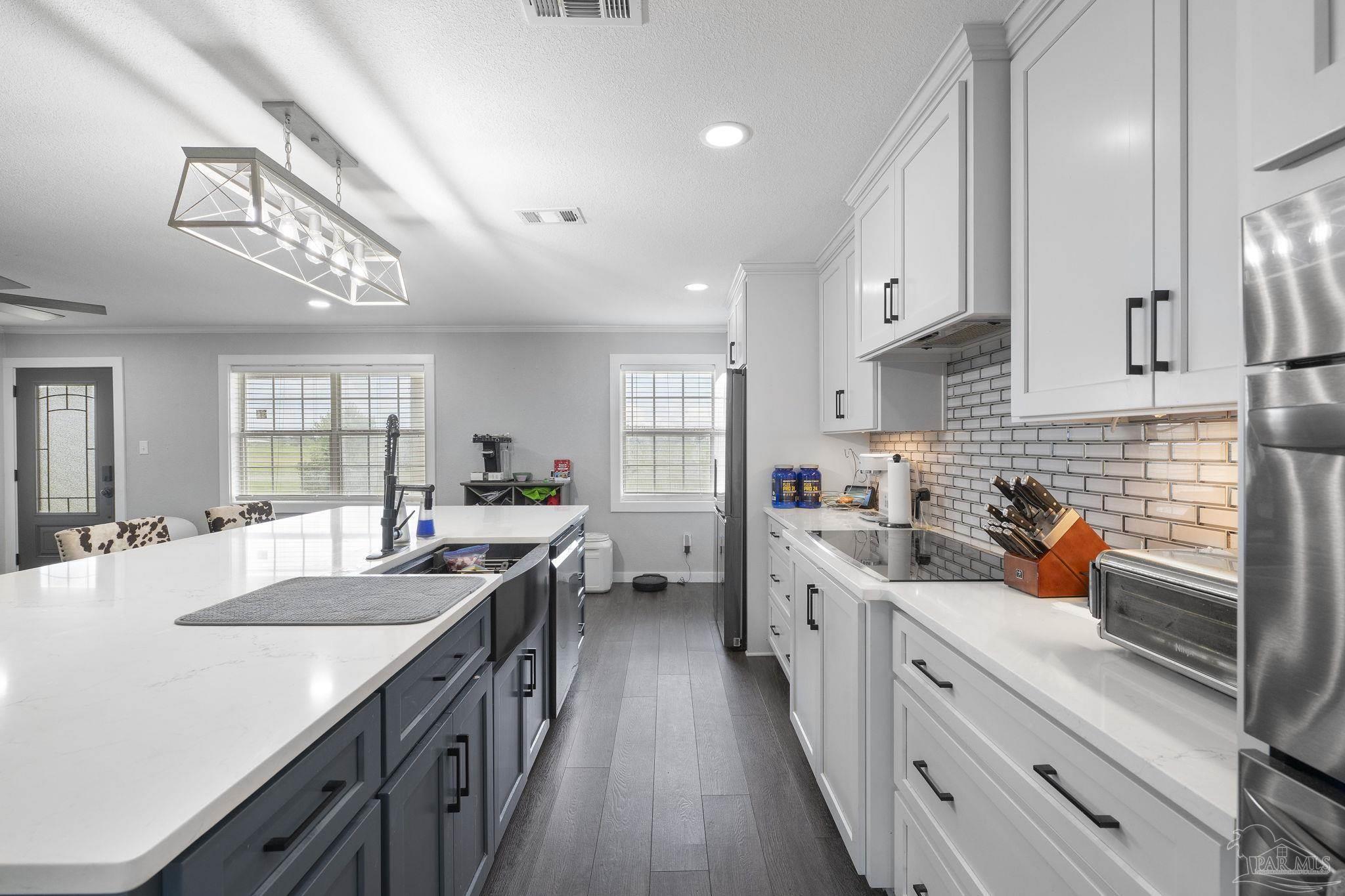 2065 Brownsdale Loop Road Jay, FL 32565 - Photo 9 of 25 a kitchen with a sink stove cabinets and wooden floor