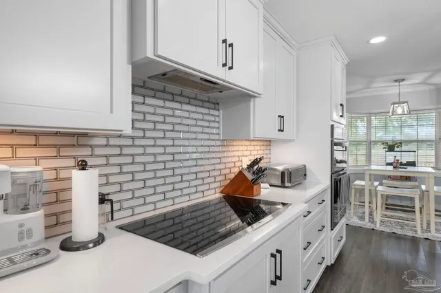 a kitchen with stainless steel appliances granite countertop a sink stove and cabinets