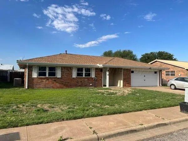 a front view of a house with a garden and yard