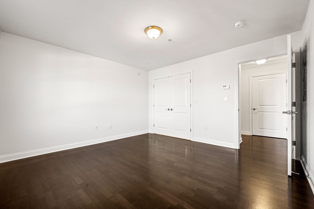 39 Fayette Street, Unit 403 Quincy, MA 02171 - Photo 11 of 24 a view of an empty room with wooden floor and a window