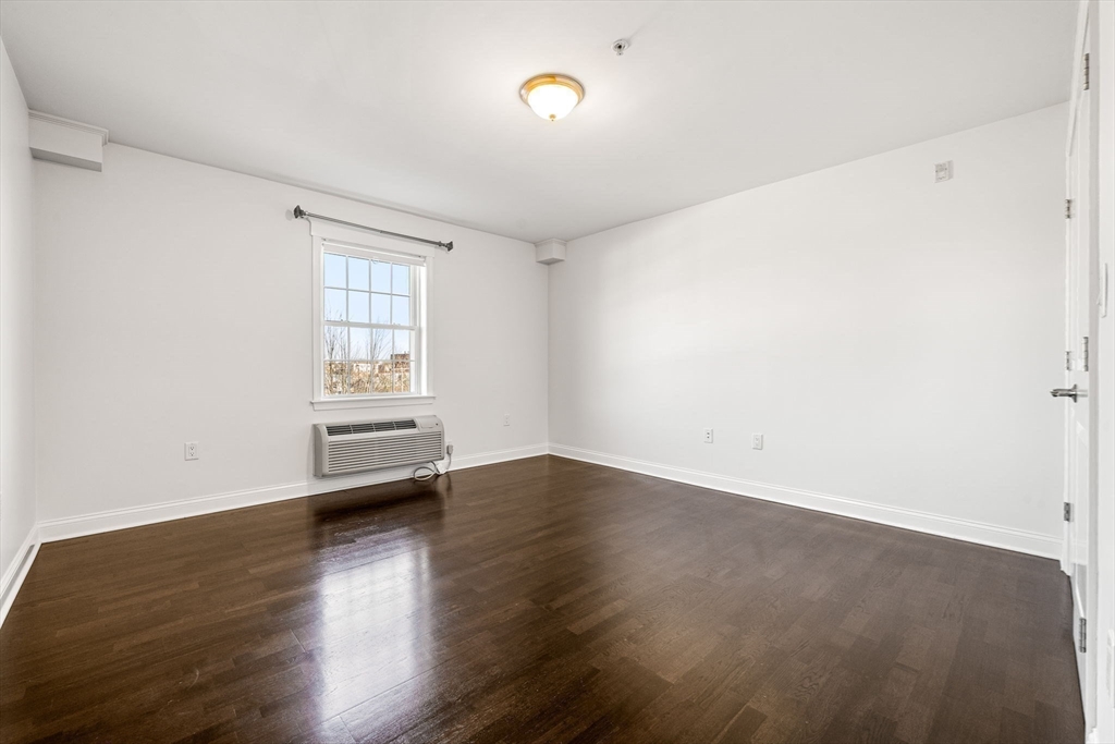 39 Fayette Street, Unit 403 Quincy, MA 02171 - Photo 12 of 24 an empty room with wooden floor and windows