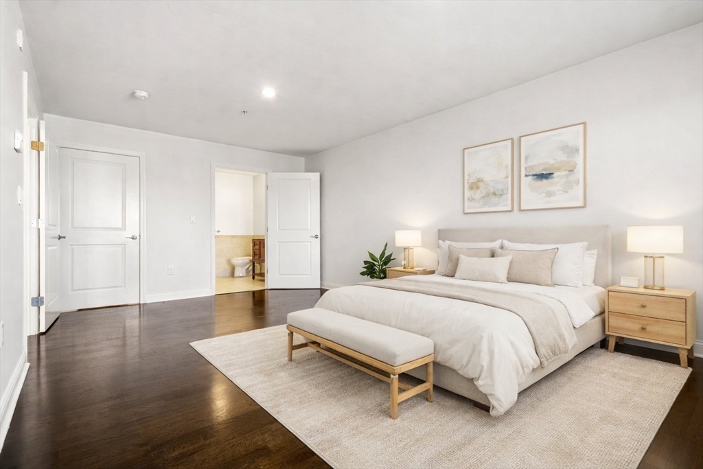 39 Fayette Street, Unit 403 Quincy, MA 02171 - Photo 13 of 24 a spacious bedroom with a bed and a table in it