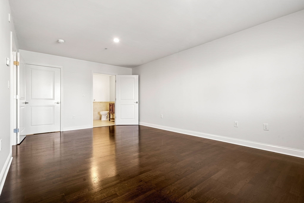 39 Fayette Street, Unit 403 Quincy, MA 02171 - Photo 14 of 24 a view of an empty room with wooden floor and a window