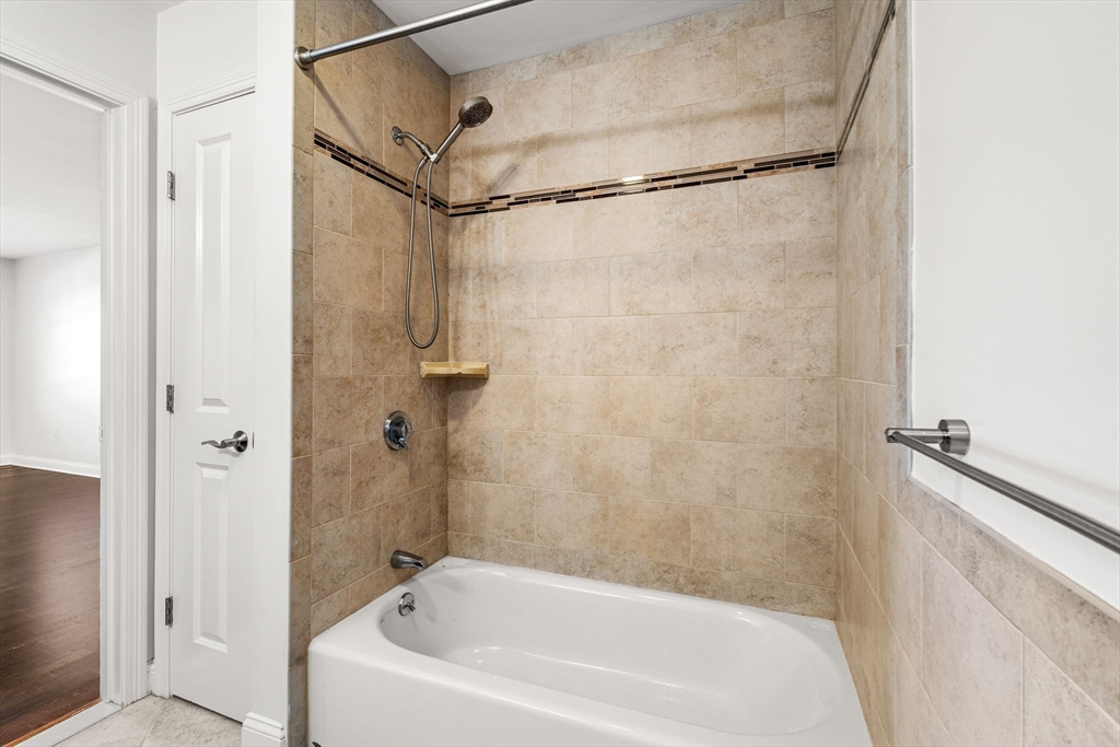 39 Fayette Street, Unit 403 Quincy, MA 02171 - Photo 16 of 24 a bathroom with a bathtub and a shower