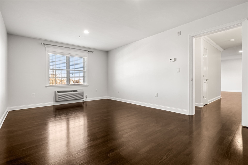 39 Fayette Street, Unit 403 Quincy, MA 02171 - Photo 17 of 24 an empty room with wooden floor and windows