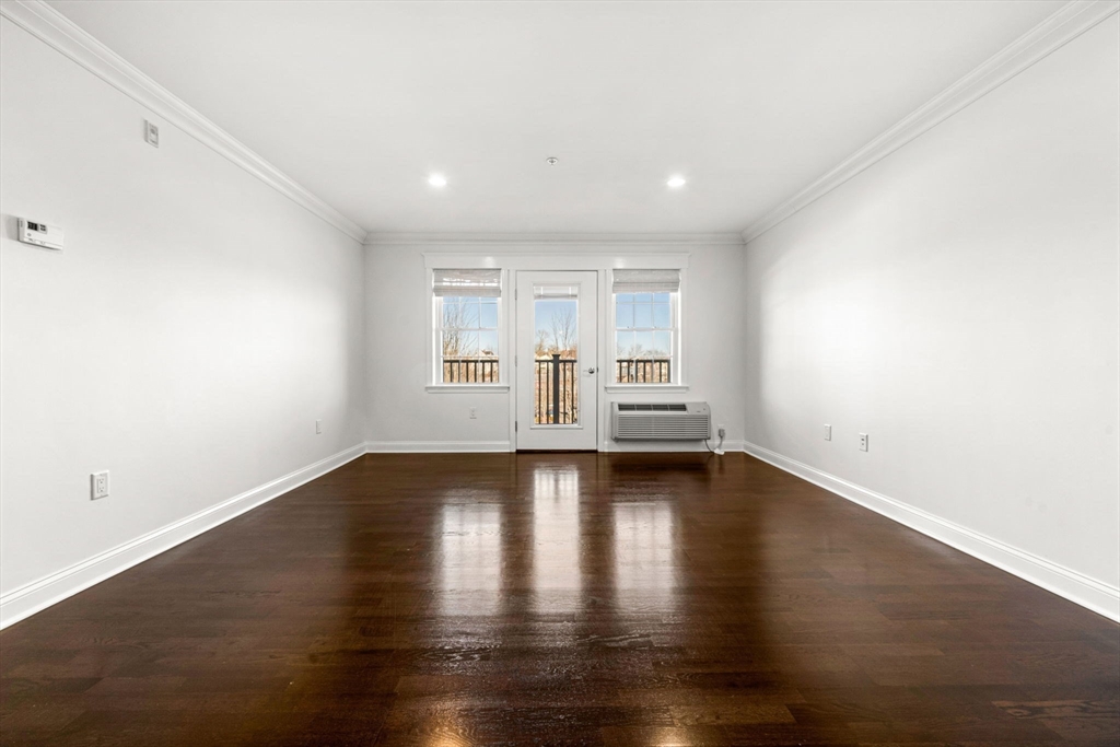 39 Fayette Street, Unit 403 Quincy, MA 02171 - Photo 2 of 24 a view of empty room with wooden floor and fan
