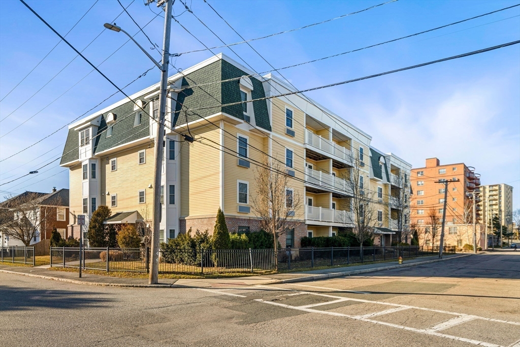 39 Fayette Street, Unit 403 Quincy, MA 02171 - Photo 23 of 24 a city street lined with tall buildings