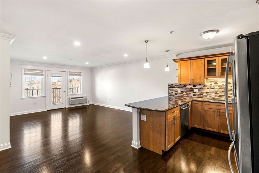 39 Fayette Street, Unit 403 Quincy, MA 02171 - Photo 4 of 24 a kitchen with stainless steel appliances granite countertop a stove and a refrigerator