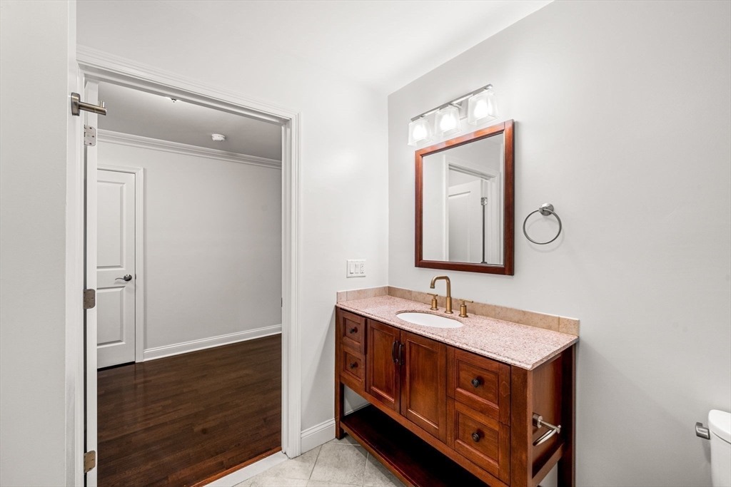 39 Fayette Street, Unit 403 Quincy, MA 02171 - Photo 7 of 24 a bathroom with a sink and a mirror