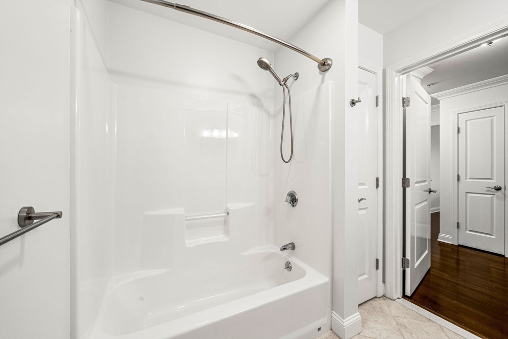39 Fayette Street, Unit 403 Quincy, MA 02171 - Photo 8 of 24 a bathroom with a bathtub and a shower