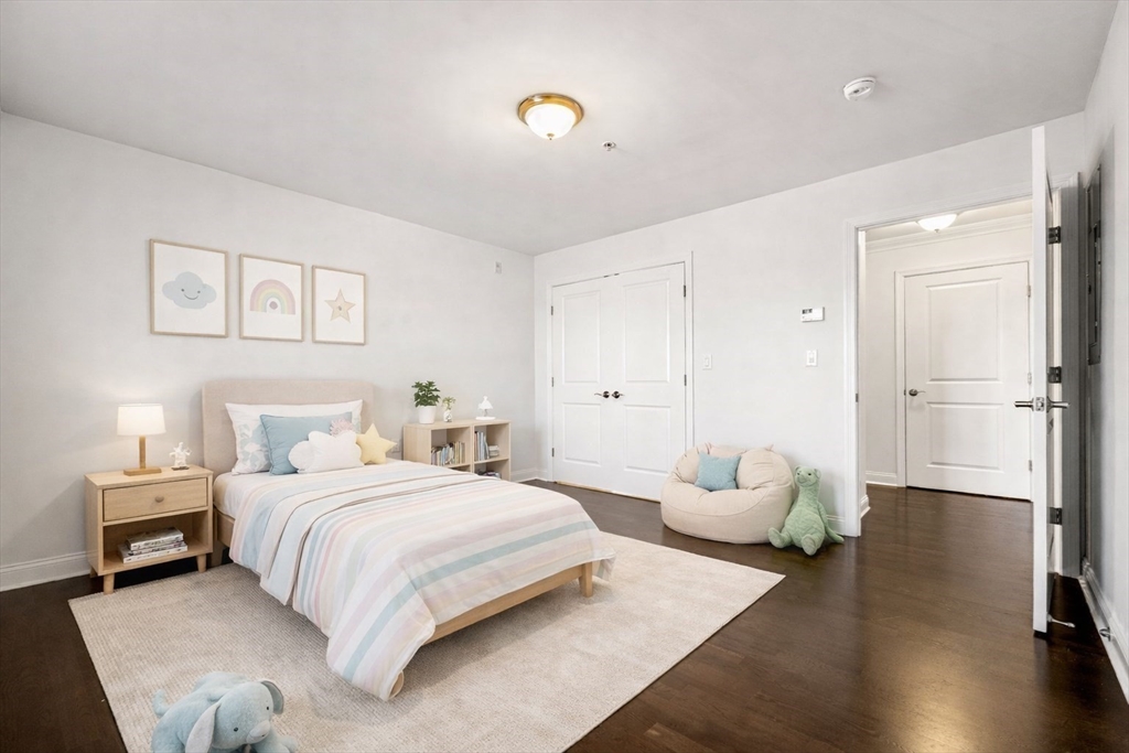39 Fayette Street, Unit 403 Quincy, MA 02171 - Photo 10 of 24 a bedroom with a bed and wooden floor