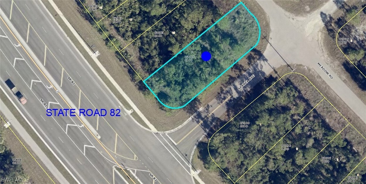 2436 Meadow Road Lehigh Acres, FL 33974 - Photo 4 of 6 a sign that is on the side of a building