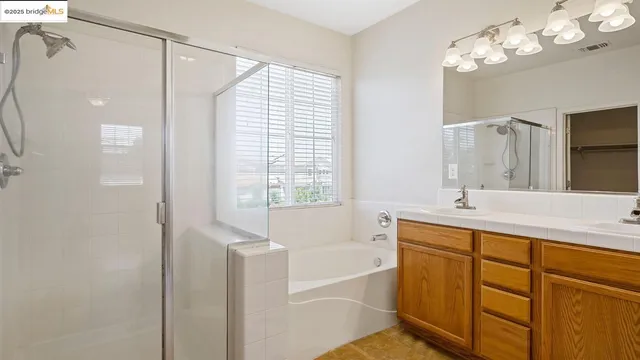 a bathroom with a tub sink and a mirror