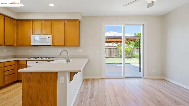 a view of kitchen with wooden floor and outdoor space