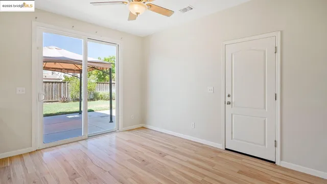 a kitchen with stainless steel appliances granite countertop a sink cabinets and wooden floor