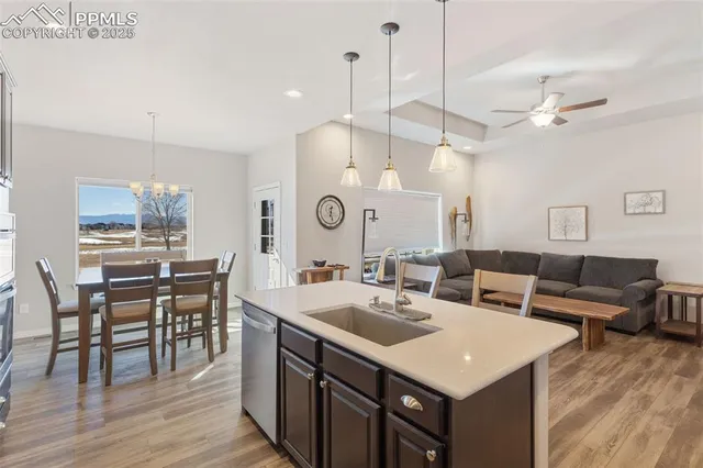 a view of a a dining table chairs and chandelier