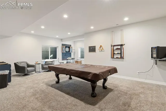 a living room with furniture a rug and a table