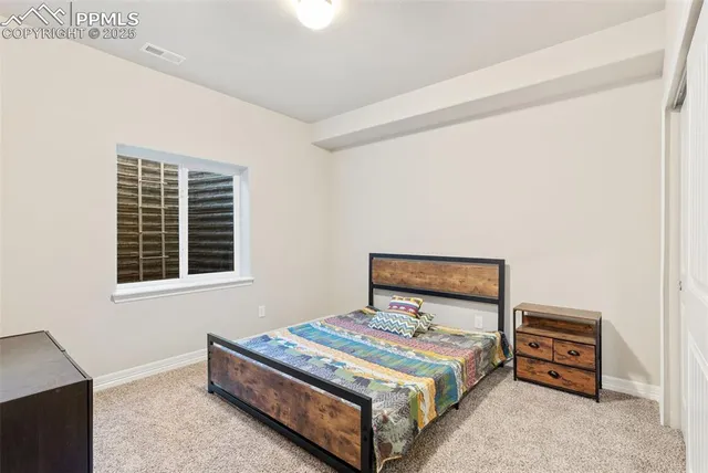 a bedroom with a bed and a night stand