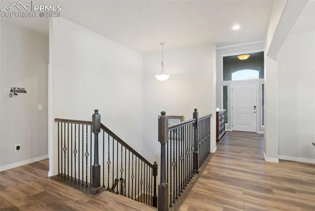 a view of a hallway with wooden floor and closet