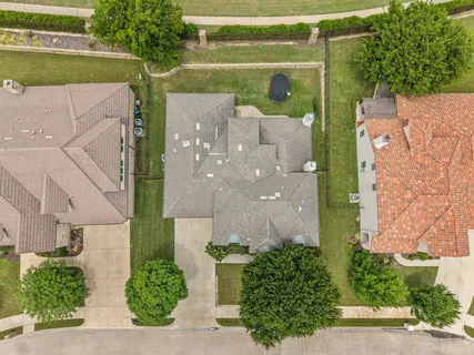 an aerial view of a house with a yard and potted plants