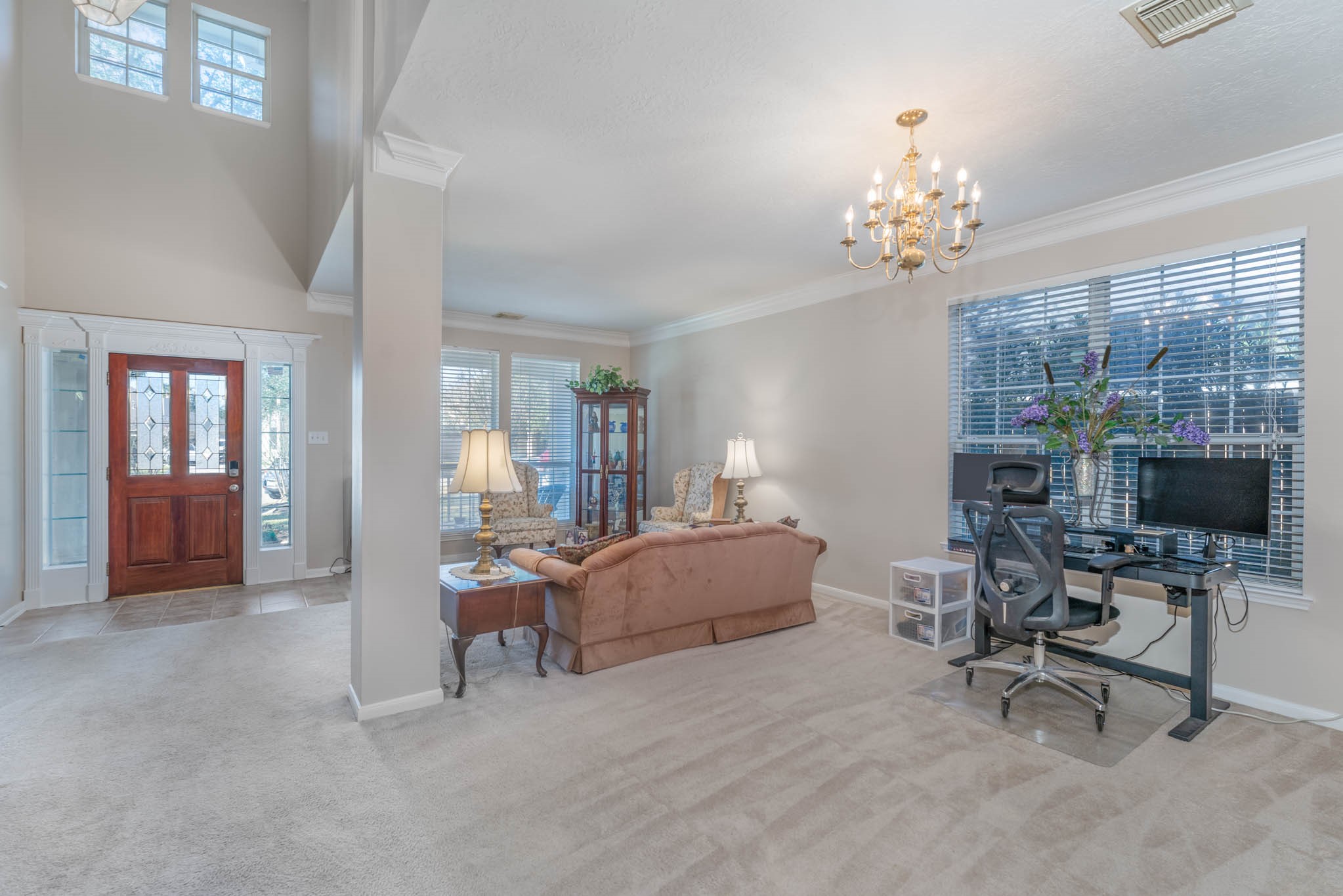 1205 Cambridge Court Seabrook, TX 77586 - Photo 8 of 47 a living room with furniture a chandelier and a flat screen tv