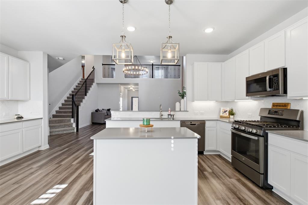 2049 Hartley Drive Forney, TX 75126 - Photo 12 of 36 a kitchen with cabinets a sink and appliances