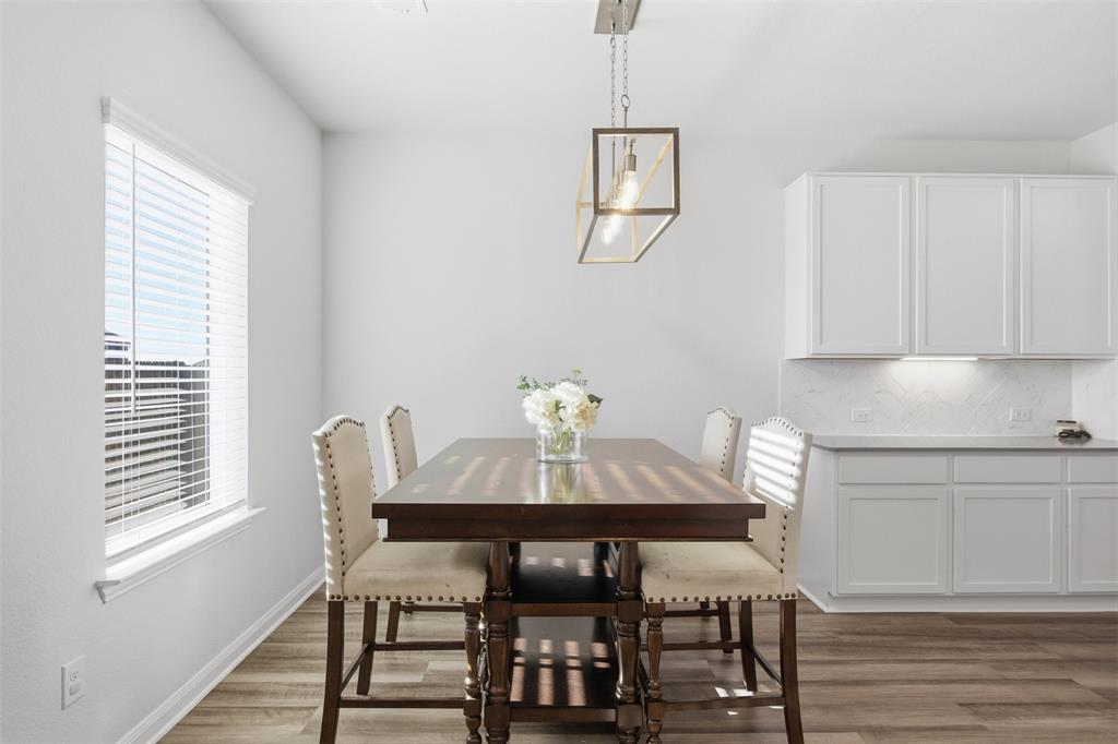 2049 Hartley Drive Forney, TX 75126 - Photo 16 of 36 a view of a dining room with furniture and wooden floor