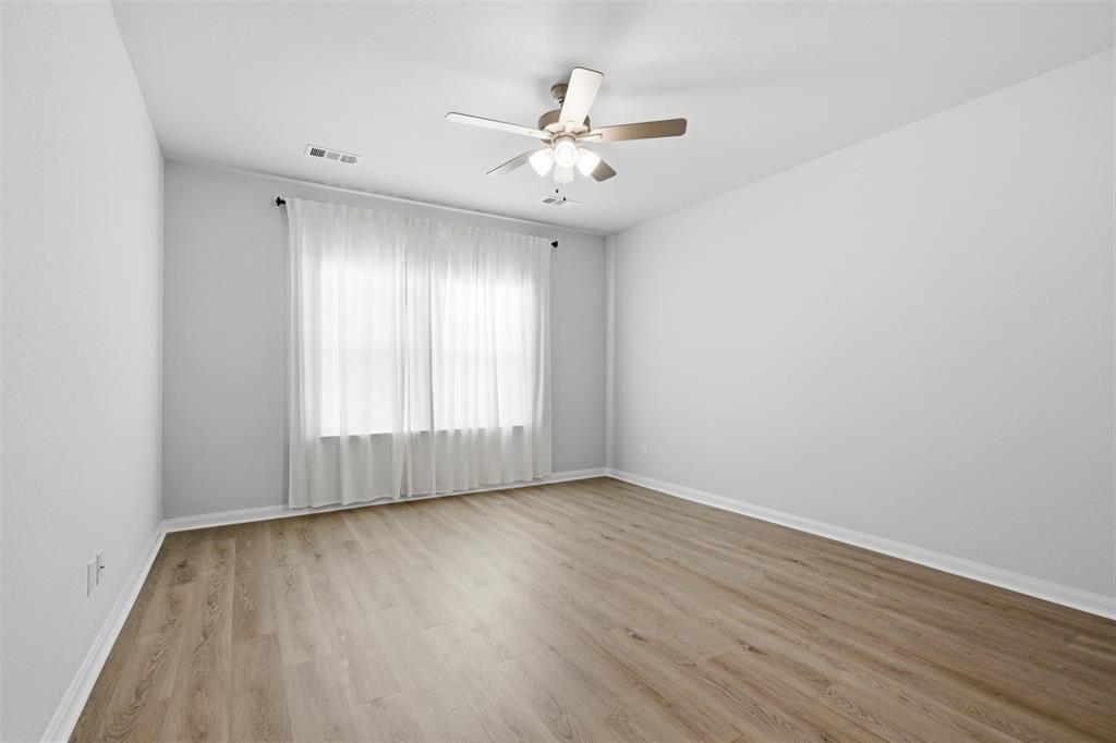 2049 Hartley Drive Forney, TX 75126 - Photo 17 of 36 wooden floor in an empty room with a window