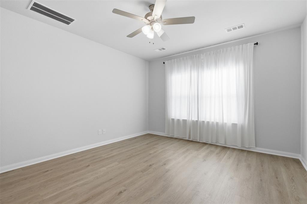 2049 Hartley Drive Forney, TX 75126 - Photo 18 of 36 an empty room with wooden floor and windows