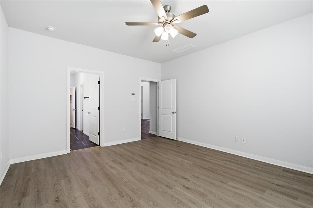 2049 Hartley Drive Forney, TX 75126 - Photo 19 of 36 an empty room with wooden floor and fan