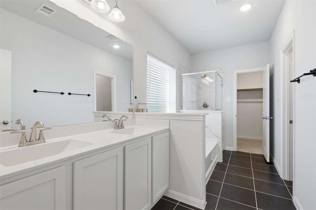 2049 Hartley Drive Forney, TX 75126 - Photo 20 of 36 a bathroom with a double vanity sink a mirror and a shower