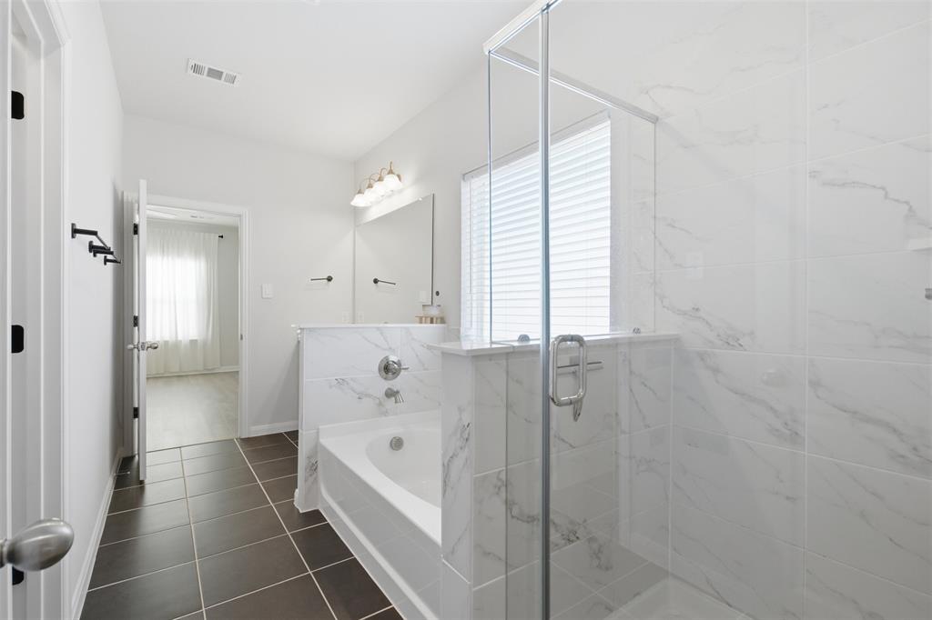 2049 Hartley Drive Forney, TX 75126 - Photo 22 of 36 a bathroom with a bathtub and a shower