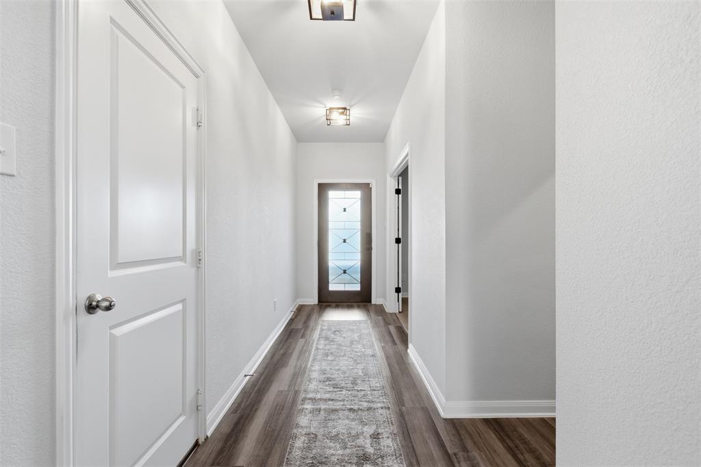 2049 Hartley Drive Forney, TX 75126 - Photo 3 of 36 a view of a hallway with wooden floor and closet