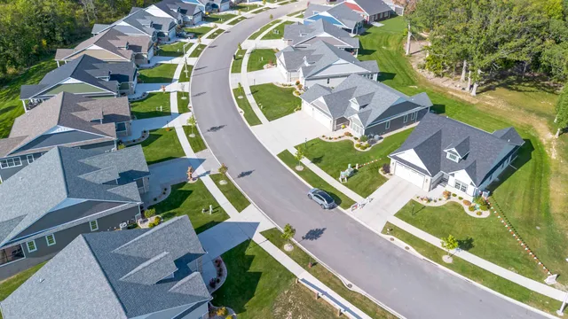 a spacious bedroom with a bed and a chandelier