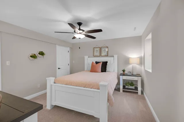 a bedroom with a bed and a desk