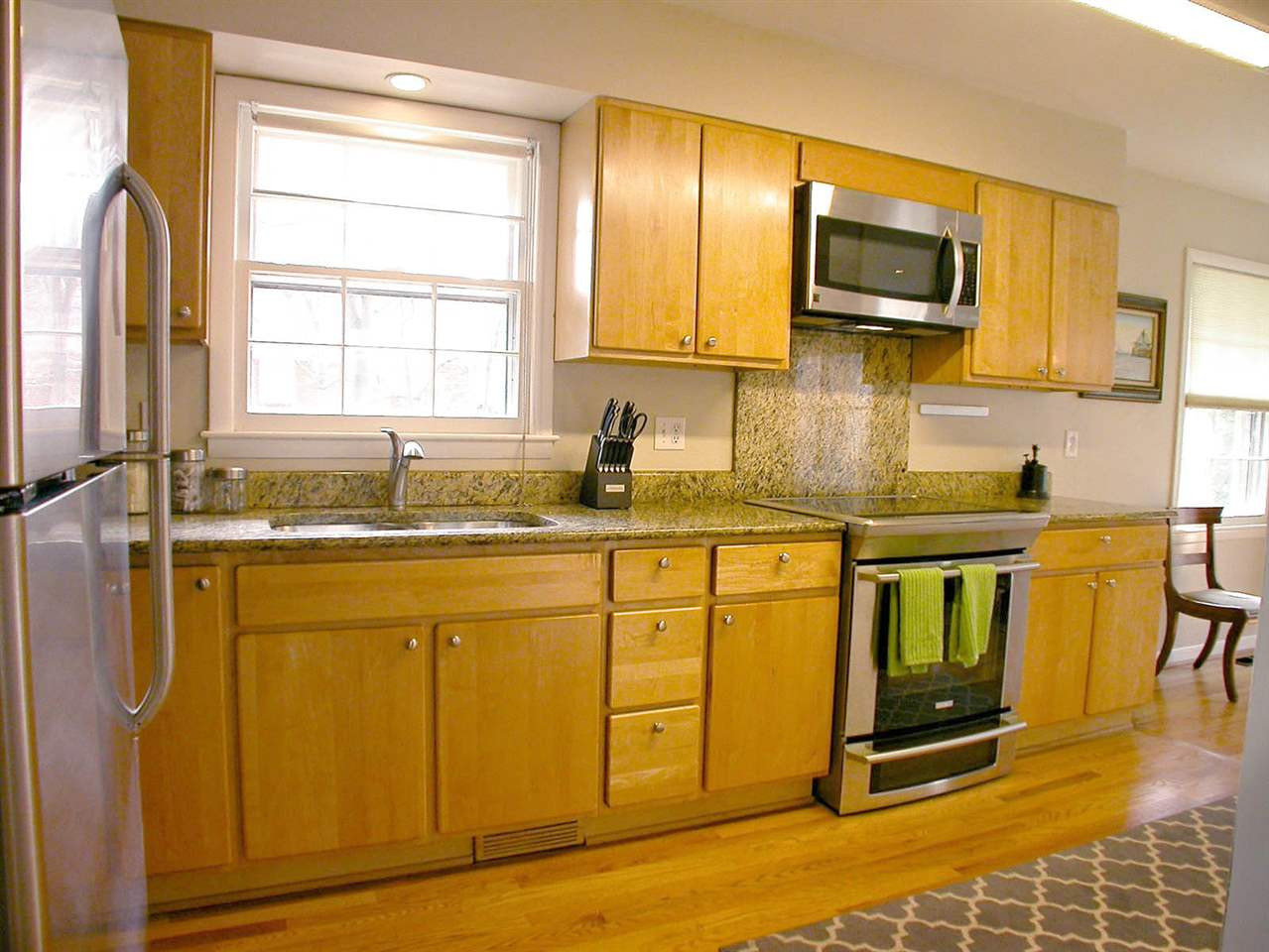 4709 Wedgewood Street Raleigh, NC 27612 - Photo 12 of 25 New appliances, sink, faucet and plumbing in this galley kitchen. The kitchen also boast new granite countertops and backslash. Kitchen