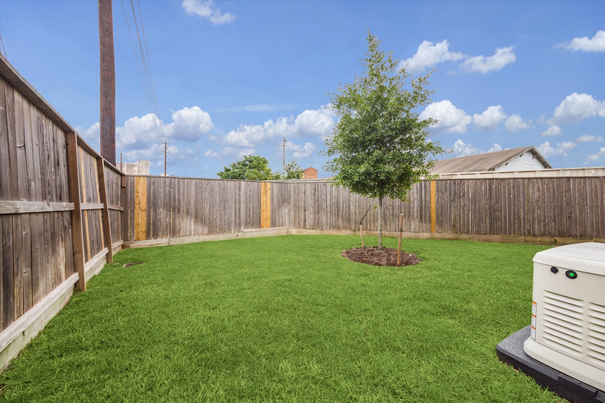 2803 Hicks Street Houston, TX 77007 - Photo 16 of 16 a view of a backyard with grass & a fence
