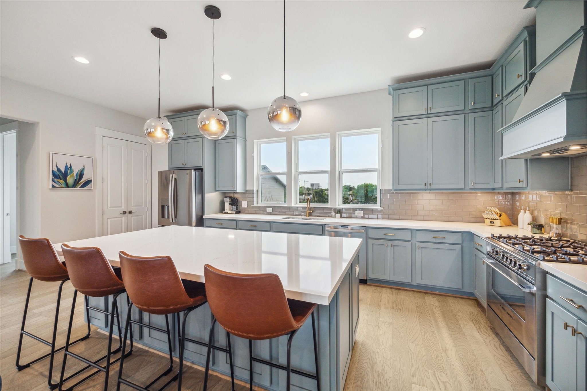 2803 Hicks Street Houston, TX 77007 - Photo 9 of 16 a kitchen with a dining table chairs sink and cabinets