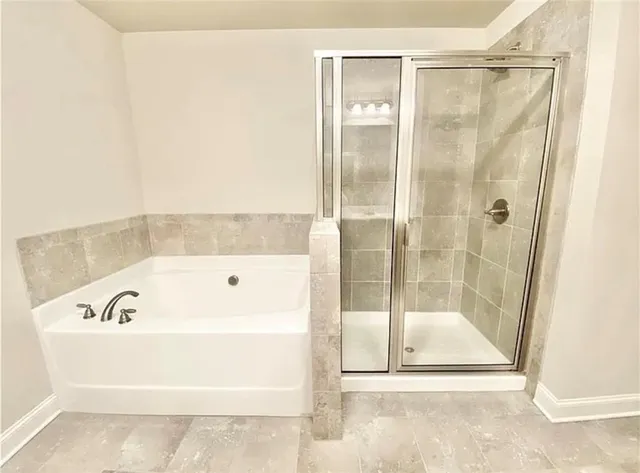 a bathroom with a bathtub and a shower
